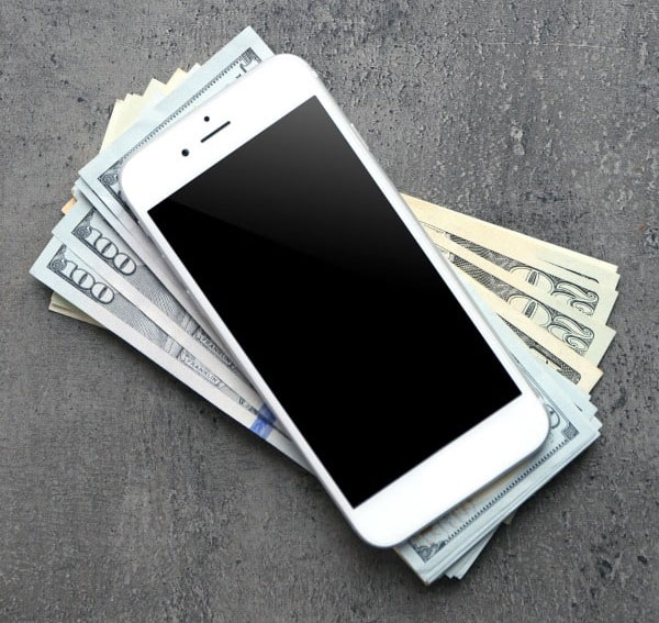 iphone on top of a pile of money